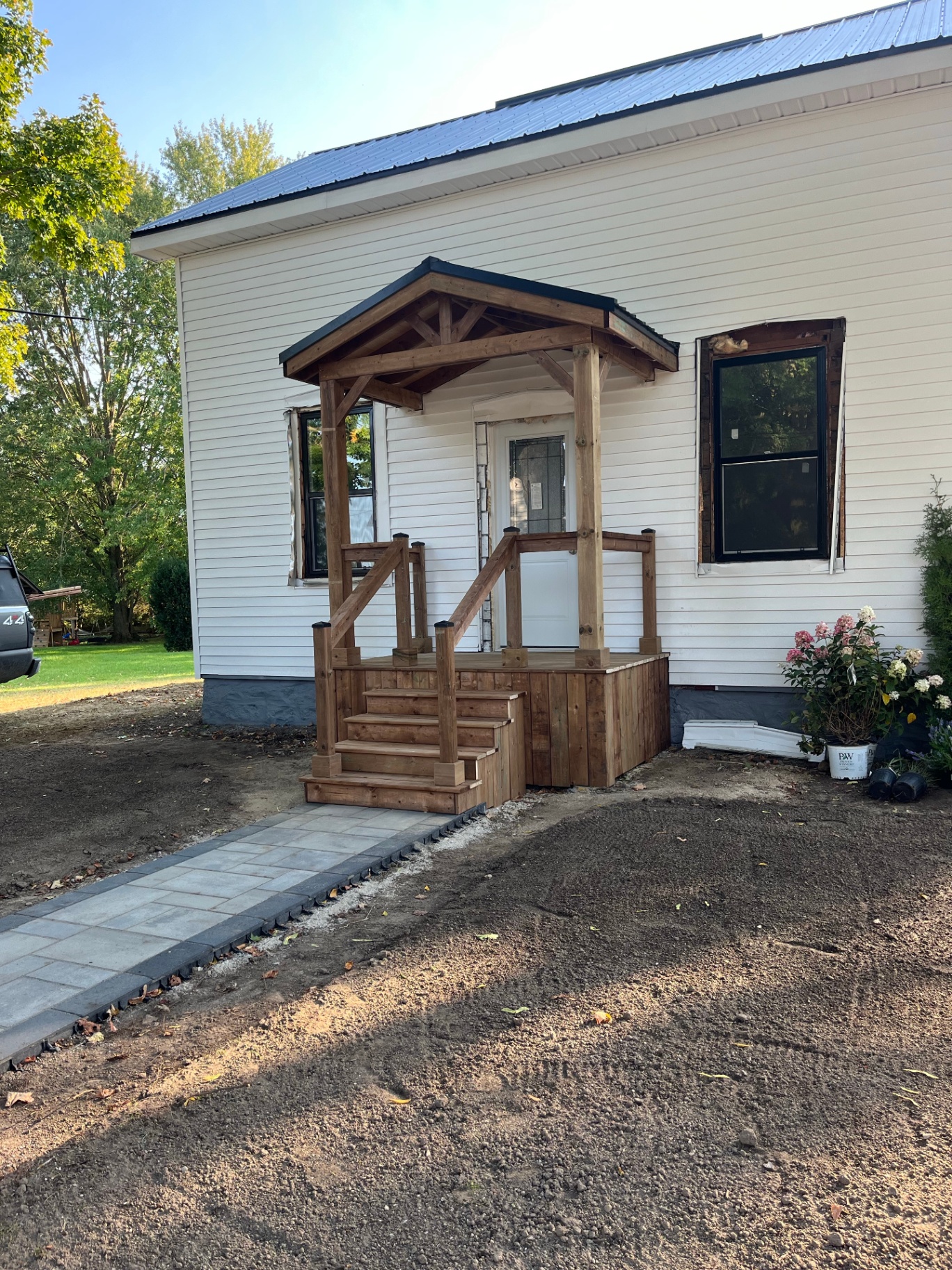 Completed timber-style front porch with steps and fresh exterior finish
