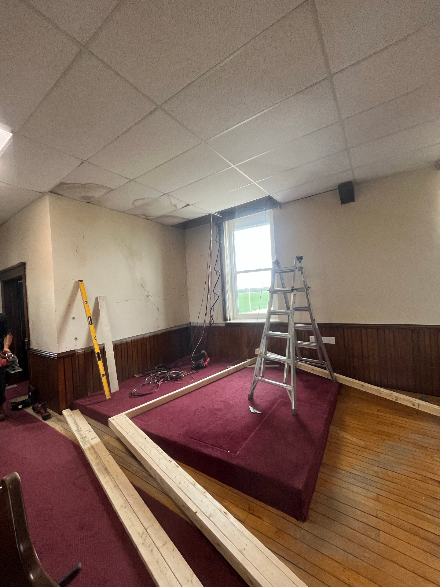 Interior renovation with new framed insulated room built inside a larger hall space