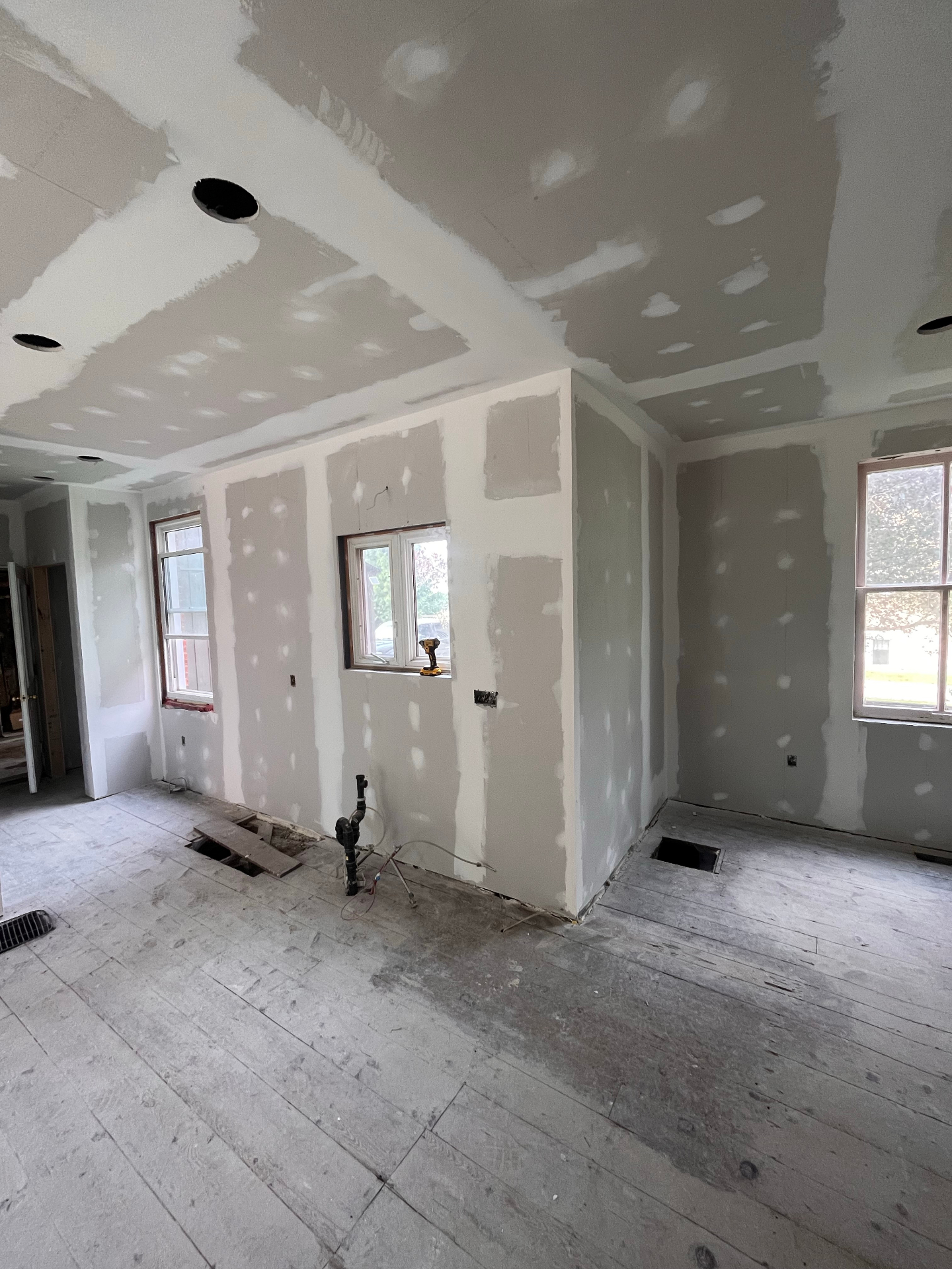 Interior remodel in progress with fresh drywall and mudding ready for paint